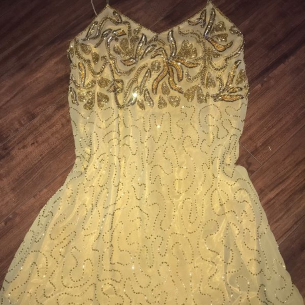 A gold dress with gold beads
